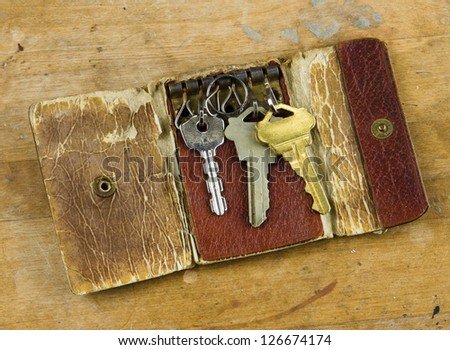 An old key wallet with three keys.
