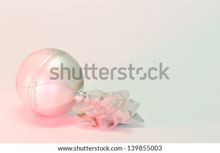 Christmas ornament and bow with red accent lighting with lots of room for text