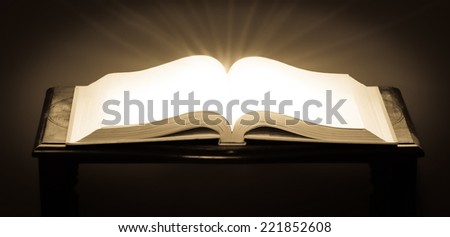 An open book with glowing blank pages and light rays coming from the pages with trendy processing