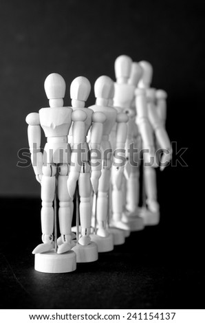 A group of artist manikins in a row or line