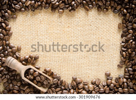 A burlap background with a coffee bean border suitable for a business card or invitation template with plenty of copy space