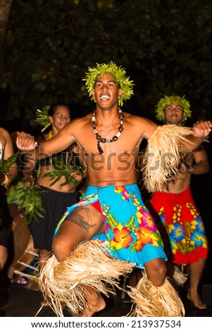 TAHAA, FRENCH POLYNESIA - CIRCA 2014: Polynesian men and women perform traditional dance circa 2014 in Tahaa. Polynesian dances are major tourist attraction of luxury resorts of French Polynesia.