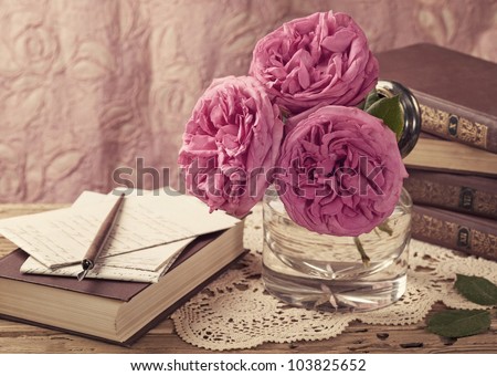 Pink roses and old books and letters