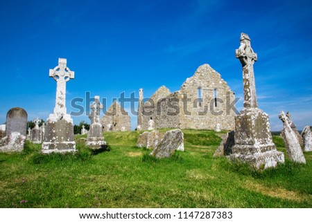 Clonmacnoise Cathedral  with the typical crosses and graves. The monastery ruins. Ireland
