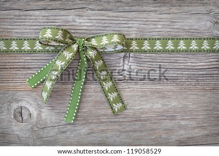 Green ribbon on wooden background
