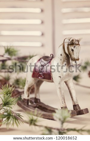 Wooden rocking horse on white table