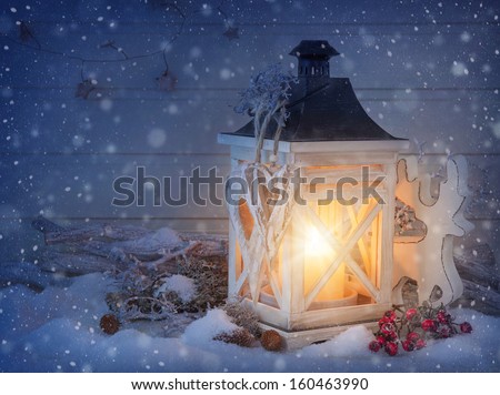Burning lantern and christmas decoration in the evening