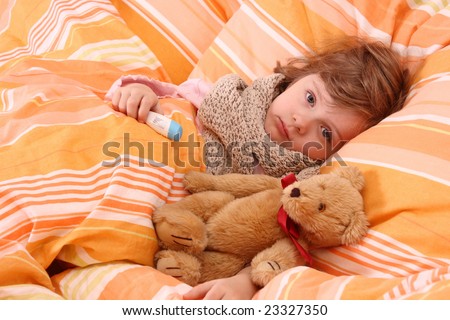 Little girl lying sick in bed