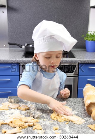 Little girl baking cakes