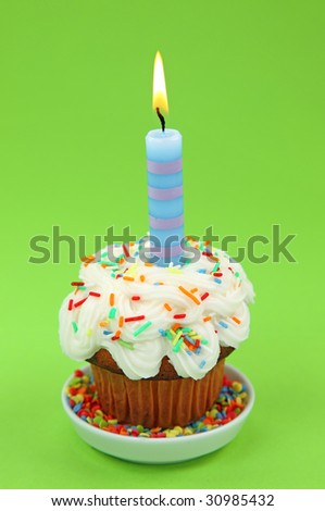 Blue birthday candle on green background