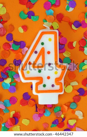 Number four birthday candle on orange background