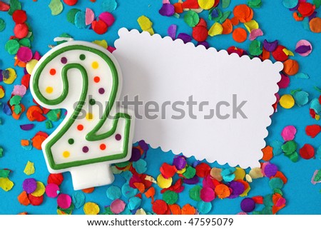 Number two birthday candle on blue background