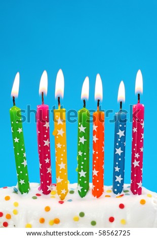 Colorful birthday candles on blue background
