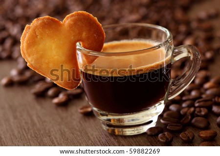 Espresso coffee with cake on brown background