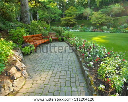 Garden benches create cozy meditative corner in front of mowed lawn