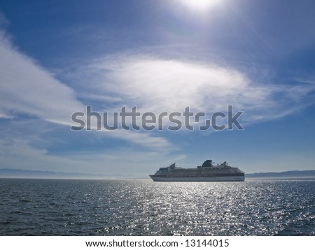 Cruise ship in the ocean lit by the sun