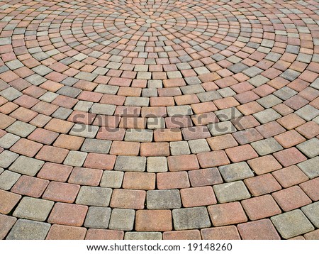 two-colored paving stone creates circular pattern on a plaza