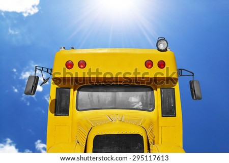 close up of school bus with blue sky