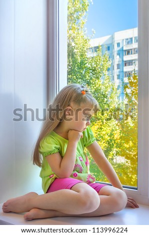 Sad girl in the window