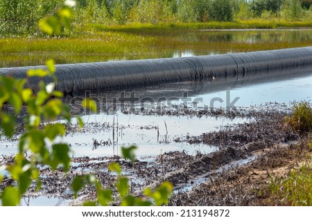 Spilled oil around the oil pipeline Spilled oil around the oil pipeline