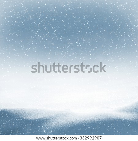 Winter background with snowdrifts and the falling snow
