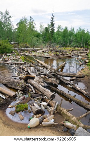 Jam from garbage and old trees on river in Western Siberia. The irresponsible relation to the nature