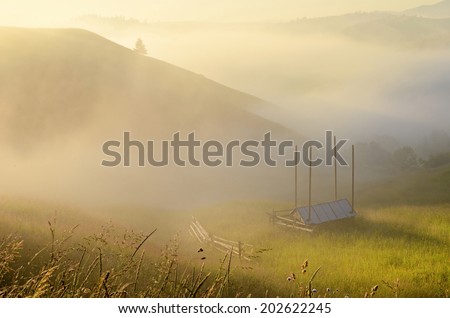Mystical landscape with slopes of the mountains in the morning mist