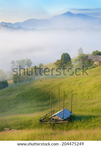 Magic landscape at sunrise in the mountains in the fog