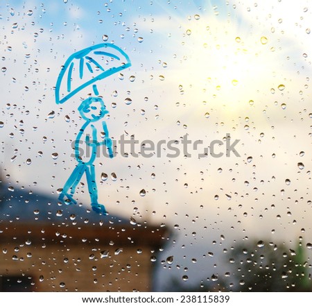 Picture of man with an umbrella on a window in the drops of rain in the sun as rays (optimism, despair improvements - concept)