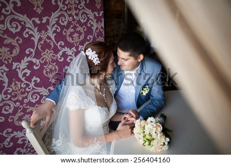 happy woman, man sitting at table in cafe, restaurant. beautiful couple of young people talking, holding hands, smiling. wedding reception. portrait of happy persons in love. new family lifestyles