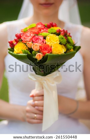 wedding flowers. close-up. beautiful young bride with wedding bouquet in hands. close up woman holding flowers. vertical photo. wedding day.
