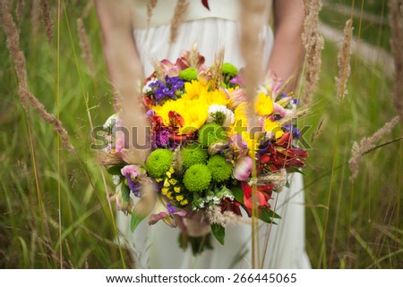 wedding flowers. close-up. beautiful young bride with wedding bouquet in hands. close up woman holding flowers. horizontal photo. wedding day