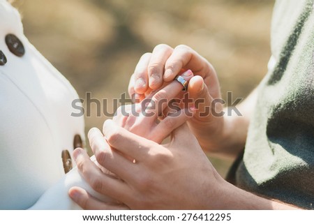 hands of wedding heterosexual couple. groom put ring on finger of bride. wedding couple in wedding day. people in love. hands of man and woman. wedding celebration.