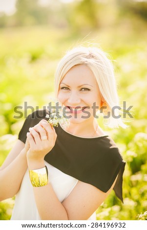 Young  business woman having rest outside after hard day in office. Freedom concept. Lady having fun in spring or summer meadow. Free happy girl portrait. Successful person. Success. Looking at camera