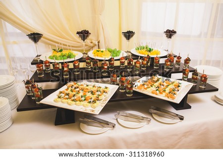 Catering for party. Close up of sandwiches, appetizers and fruit. Canape