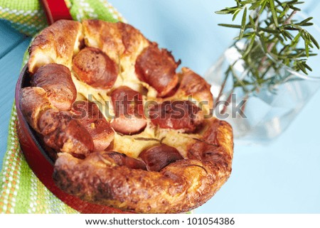 Toad in the Hole. A traditional English dish of sausages cooked in Yorkshire pudding batter.