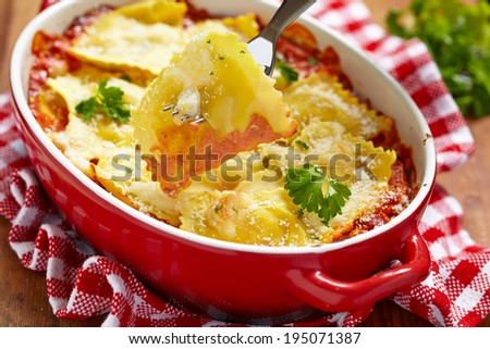Baked ravioli with ham and cheese in tomato sauce