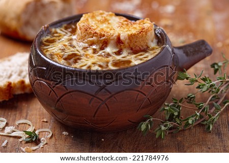 French onion soup on rustic wooden table