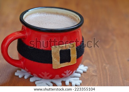 Santa belly. Red mugs with hot chocolate and marshmallows