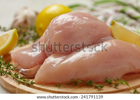 Raw chicken breasts with lemon and garlic