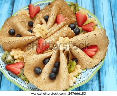 Funny butterfly shaped crepes with berries for kids