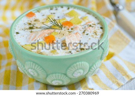 Salmon soup with cream, potatoes, carrots and dill