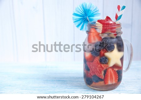 Patriotic drink cocktail with strawberry, blueberry and apple