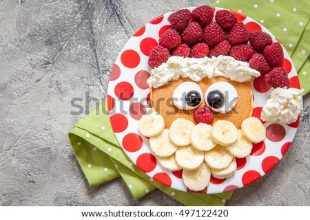 Christmas Santa pancake with raspberry and banana for kid breakfast