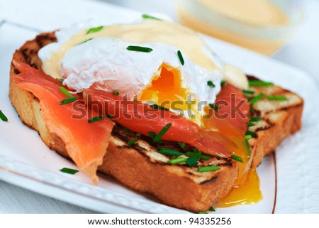 Egg benedict with hollandaise sauce and smoked salmon on toast. Delicious breakfast