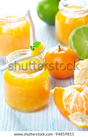 Mandarin and lime marmalade in a jars with fresh fruits
