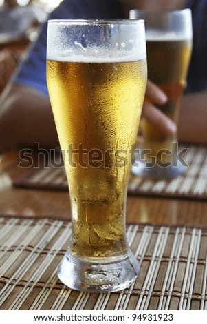 Man with two glasses of beer in open air pub