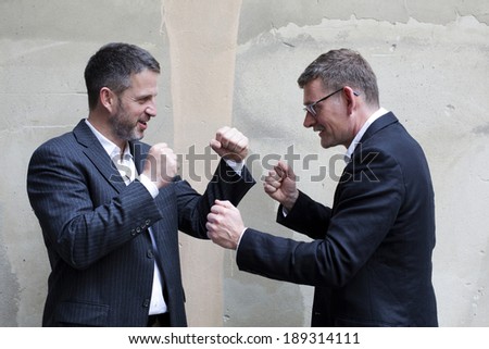 two men in suits boxing