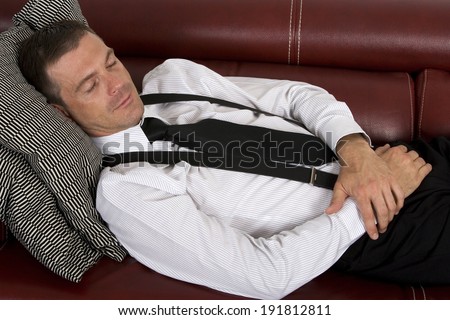 businessman sleeping on couch