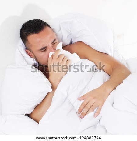 man lying in bed with a cold
